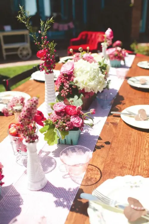 a simple and cute summer tablescape with a striped runner, bold and neutral blooms, simple porcelain and neutral tags