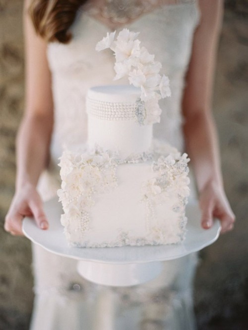 a refined round and square wedding cake decorated with neutral sugar blooms and beads is a stylish and cool idea