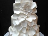 a white wedding cake decorated with white sugar blooms is a non-typical and very romantic idea