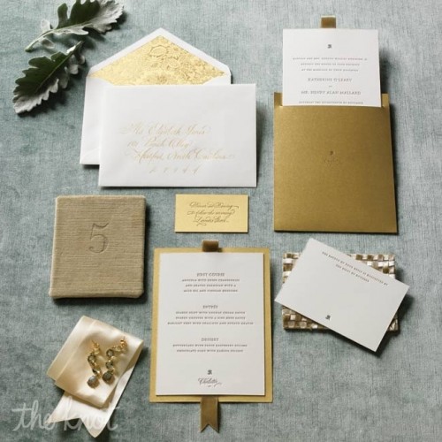 a stylish white and gold wedding invitation suite with pretty printing and ribbons for a refined wedding