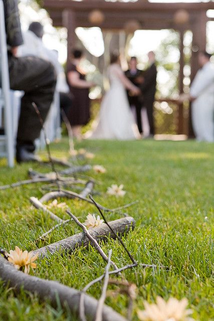 super delicate spring wedding aisle decor with branches and yellow blooms is a cool idea that feels and looks like spring