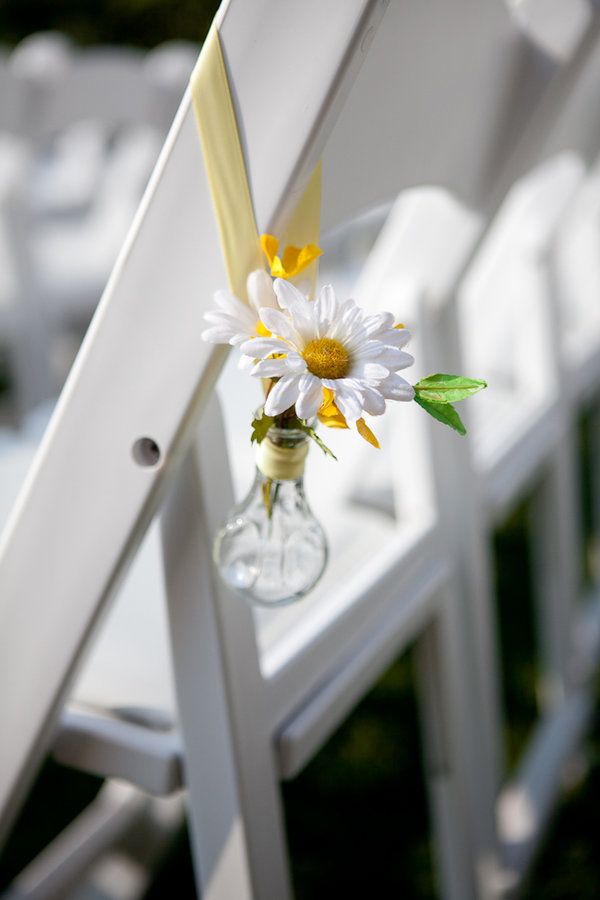 a bulb with yellow ribbon and a white chamomile is a pretty solution for a spring or summer wedding aisle, it looks super fresh and relaxed