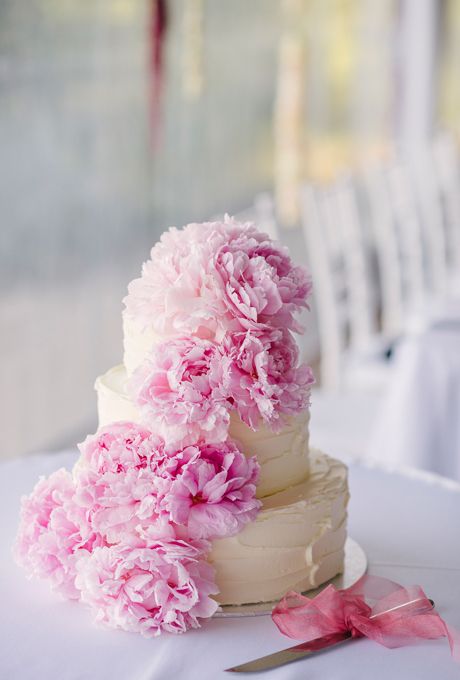 a white textural buttercream wedding cake topped with pink peonies is a beautiful and fresh idea for both a spring or a summer wedding