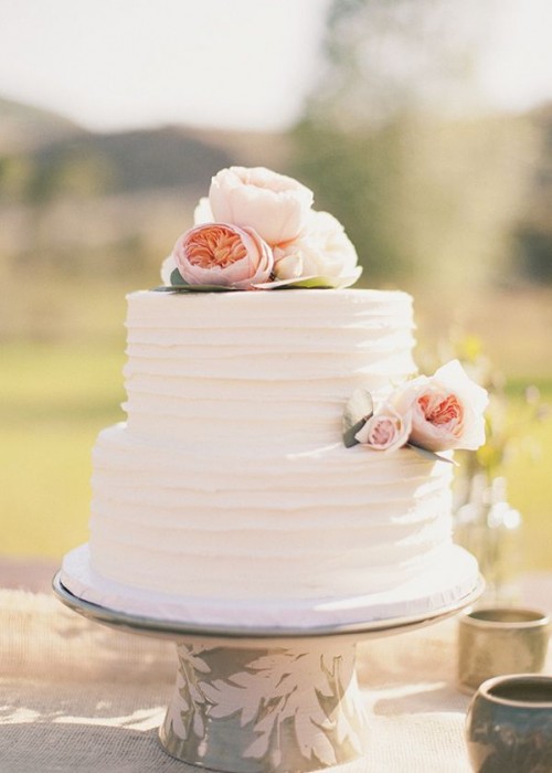 a white textural buttercream wedding cake with blush peony roses is a pretty idea for a spring wedding