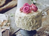a white textural buttercream wedding cake topped with pink peony roses is a gorgeous solution for a spring or summer wedding