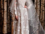 a whimsy wedding dress of textural fabric, with star and sun appliques and embroidery plus a long veil for a statement look