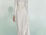 a modern plain wedding dress with a high neckline, long sleeves and a layered skirt with a train is chic
