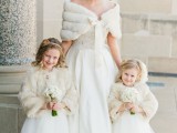 a romantic vintage-inspired wedding ballgown with a lace bodice and a plain full skirt plus a faux fur coverup