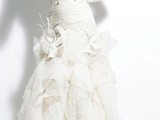 a striped wedding dress with lace detailing and flowers looks out of the box and bold