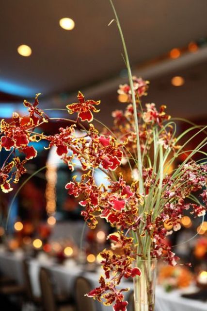 a super bright fall floral wedding centerpiece is a cool idea for a vineyard or any other wedding