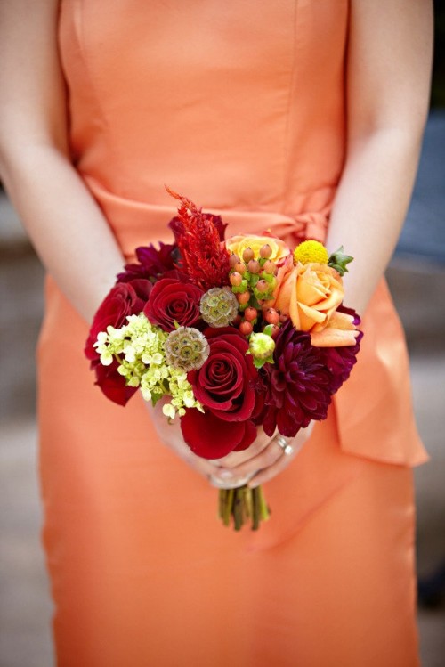 a super bold fall vineyard wedding bouquet of orange, yellow and deep red blooms is a cool solution for a vineyard wedding