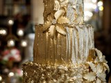 a refined textural gold wedding cake decorated with flowers and edible beading is a chic and bold dessert to rock