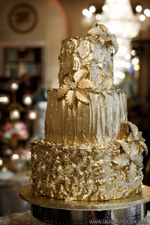 a refined textural gold wedding cake decorated with flowers and edible beading is a chic and bold dessert to rock