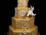 a unique octagonal gold wedding cake with sugar blooms and swans looks very spectacular