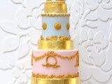 a pastel and gold wedding cake with various tiers and catchy patterns looks very chic and very stylish