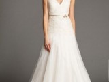 a beautiful A-line wedding dress with a V-neckline, a lace bodice and a tille skirt, a gold belt and no sleeves is a lovely idea for a vintage bridal look
