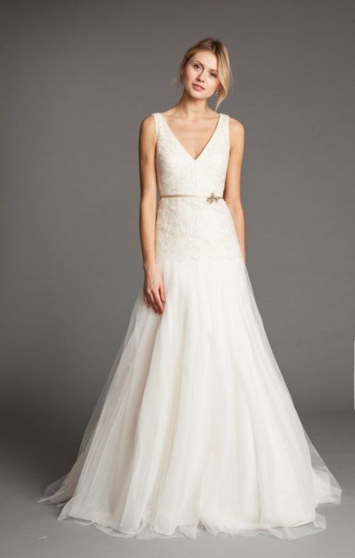 A beautiful A line wedding dress with a V neckline, a lace bodice and a tille skirt, a gold belt and no sleeves is a lovely idea for a vintage bridal look