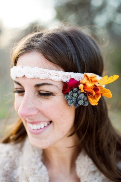 hair down accented with a fabric flower headband and some bright fresh blooms and leaves on one side for a fall boho bride