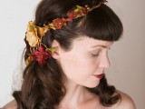 waves down with bangs and a faux floral crown in bold fall colors – burgundy, rust and tan and with faux greenery