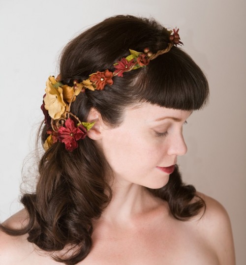 waves down with bangs and a faux floral crown in bold fall colors - burgundy, rust and tan and with faux greenery