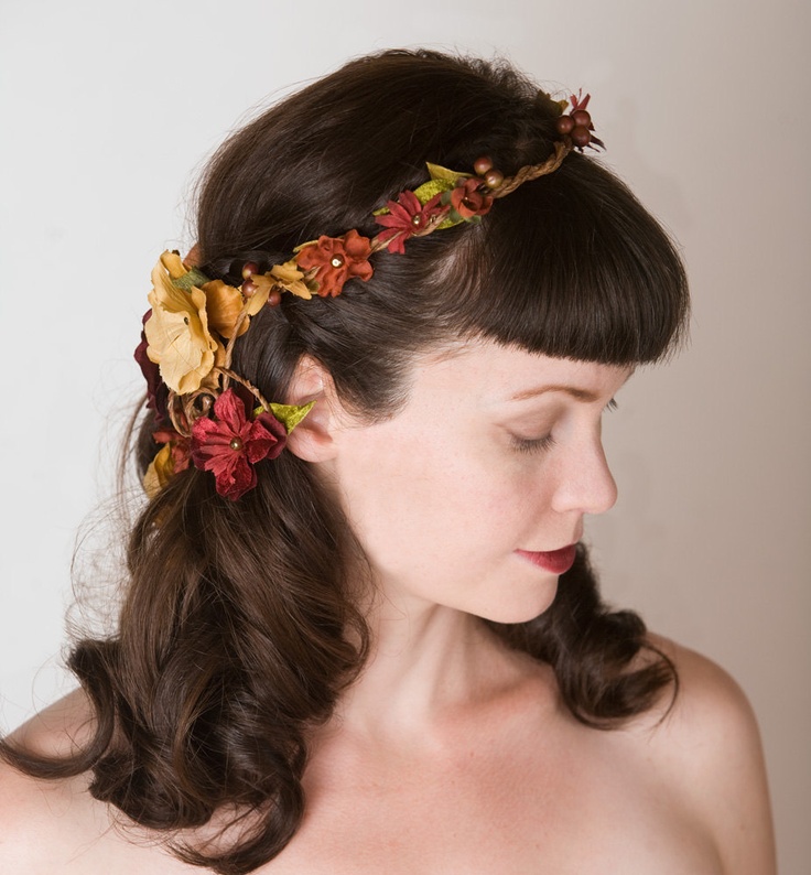 Waves down with bangs and a faux floral crown in bold fall colors   burgundy, rust and tan and with faux greenery