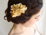a wedding updo with a large braided halo and some waves plus neutral blooms is an elegant idea for the fall