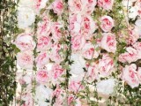 a lush pink peony and greenery floral wall as a beautiful and romantic wedding backdrop