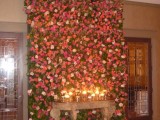 a lush floral wall with blush, orange and pink blooms can double as a wedding ceremony backdrop and as a lounge backdrop, too