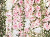 a pink peony wall with greenery is a very cute and romantic wedding decor idea