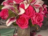 a fuchsia-colored lily and rose wedding centerpiece is super bright and statement-like