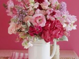 a bright and beautiful red, pink and lilac wedding centerpiece for a spring wedding
