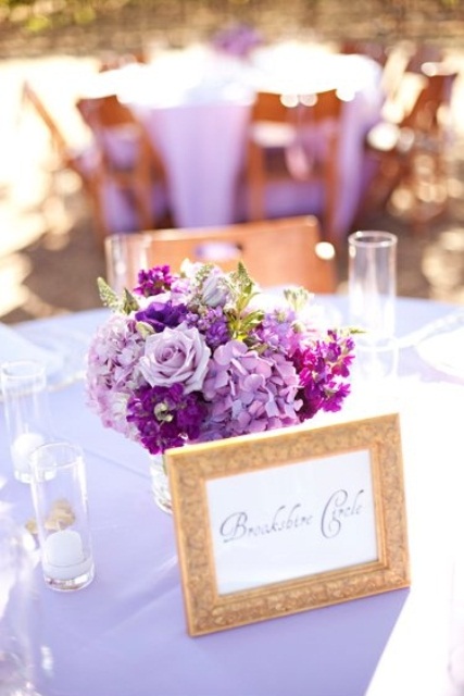 a bold lilac and purple wedding centerpiece with greenery is great for bright spring and summer weddings