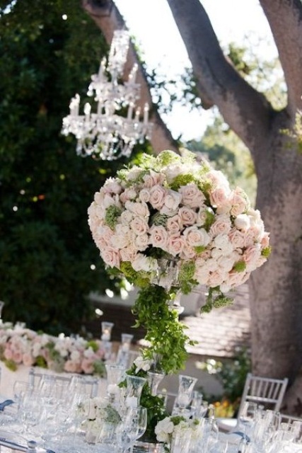 a tall topiary wedding centerpiece in light pink and greenery is a gorgeous idea for a spring wedding