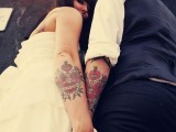 colorful hearts and flowers with eyes tattoos and Amor word on them covering the whole forearm