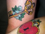 a colorful key with blooms and a heart lock in bold colors made on forearms are a perfect match
