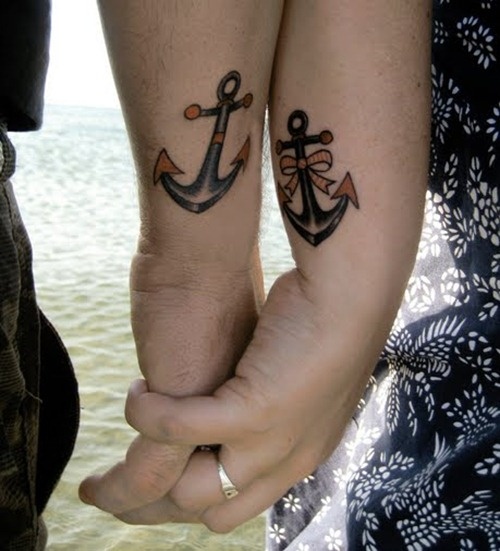 an anchor and an anchor with a bow on the wrists are romantic tattoos for a sea-loving couple