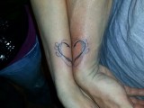 a small and cute wrist tattoo that creates a whole heart when you place your arms next to each other