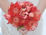 a bold wedding bouquet of pincushion proteas and pink orchids is a cool and bright idea for a summer or tropical bride