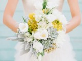 a neutral wedding bouquet of white tulips, succulents, billy balls, berries and yellow pincushion proteas