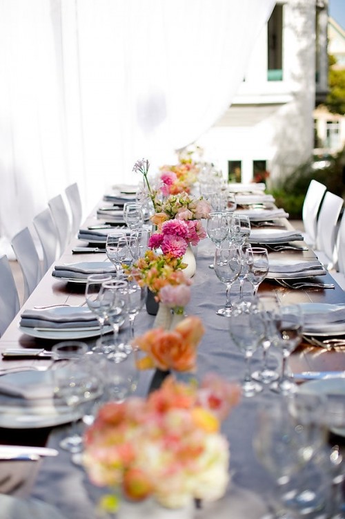 a bright spring wedding tablescape with neutral linens, bold blooms and simple and elegant glasses is all chic