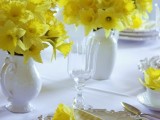 a bold spring wedding tablescape with a vintage feel, yellow plaid napkins and bright yellow blooms, refined vintage plates and glasses