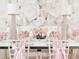 oversized white paper blooms on the wall make the backdrop fantastic, bold and catchy