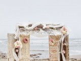 vintage doors, blooms, neutral fabric and branches make up a chic and refined wedding backdrop