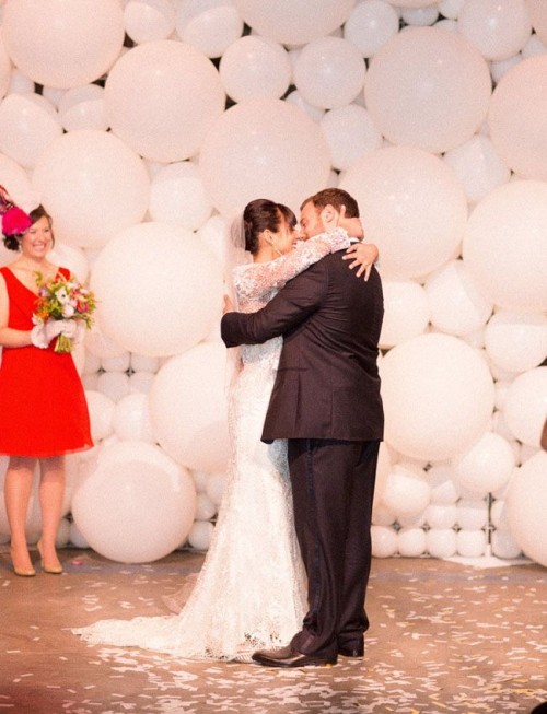 a wall of white balloons of various sizes is a gorgeously creative and fun idea with a strong party feel