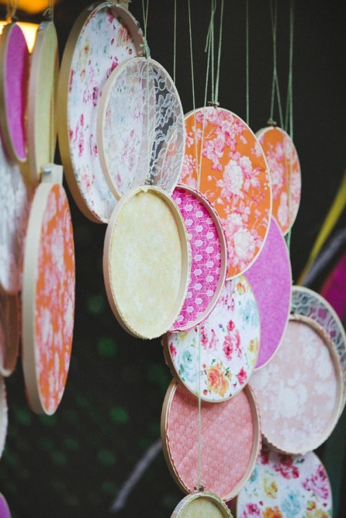 hoops with colorful fabric and lace make up a fun and bright reception or wedding backdrop