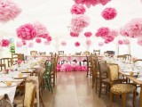 pink and blush paper balls and blooms attached to the wall and over the reception is a cool idea