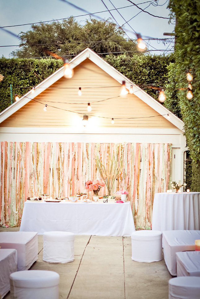 Pastel and gold stripes reception backdrop with lights is a chic idea for any wedding, from glam to rustic