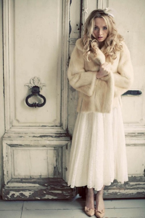 a vintage-inspired midi wedding dress and a neutral faux fur jacket are a perfect combo for a cold winter day wedding