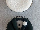 black and white wedding cupcakes imitating the bride and the groom wearing a dress and a tux
