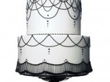 a white wedding cake decorated with black beads and patterns is a stylish and timeless idea to rock